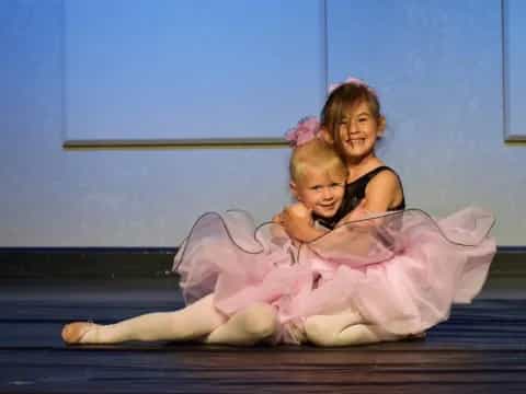 a woman and a child in a tutu