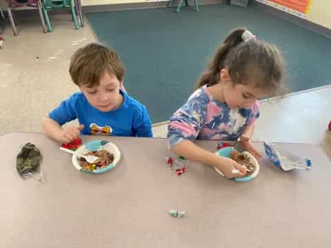 a couple of children eating
