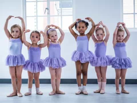 a group of girls in blue dresses