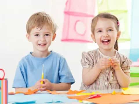 a couple of children smiling