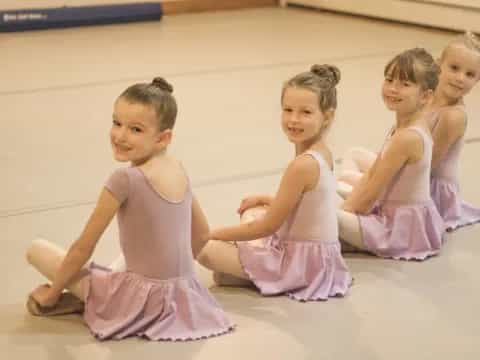a group of girls in dresses