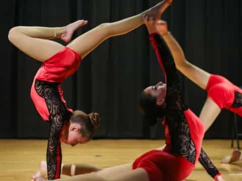a couple of women doing acrobats