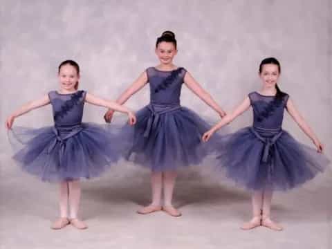 a group of girls in dresses