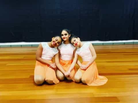 a group of women in white dresses