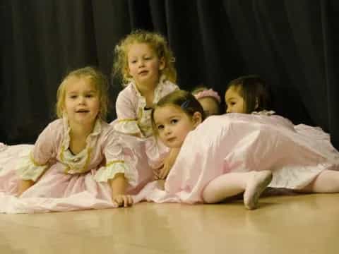 a group of girls in dresses