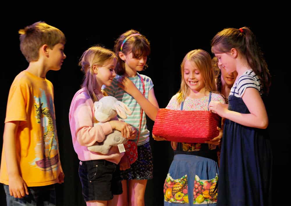 a group of children holding a stuffed animal