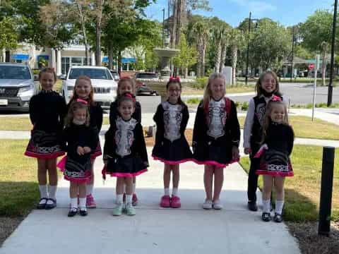 a group of girls in matching black and red uniforms