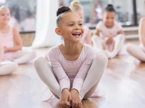 a young girl sitting on the floor