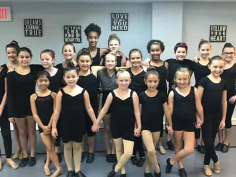 a group of women in black dresses