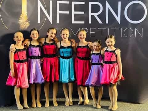 a group of girls in dresses