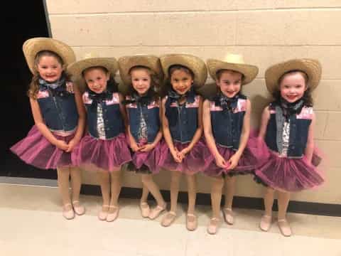 a group of girls wearing hats