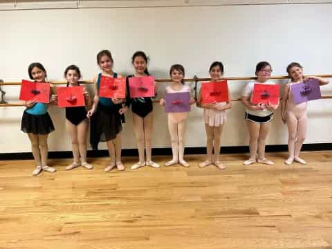 a group of girls holding signs