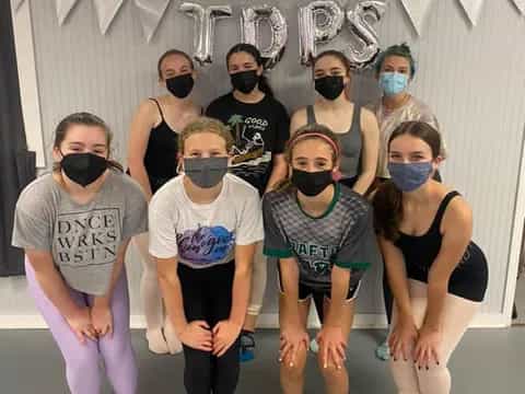 a group of people wearing masks