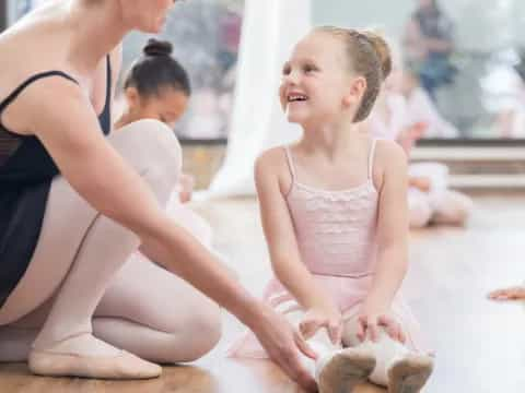 a young girl sitting on the floor