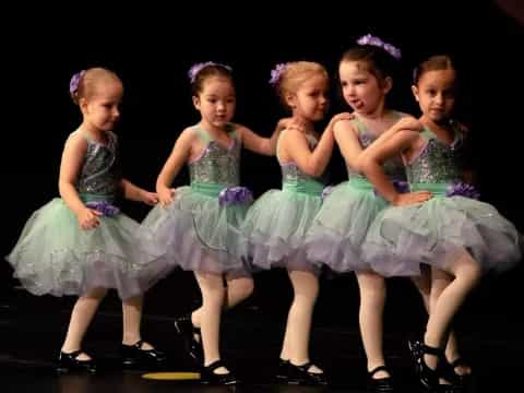 a group of girls in dresses