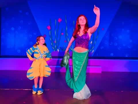 a couple of women on a stage