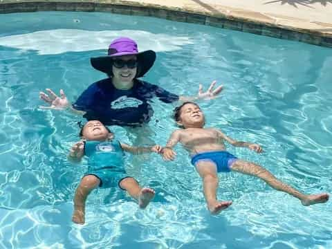 a person and two children in a pool