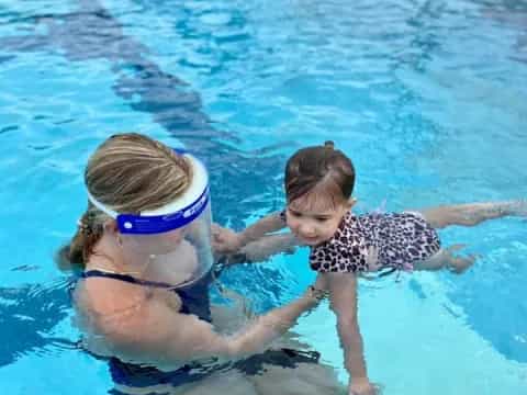 a person and a child in a pool