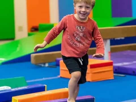 a boy standing on a mat