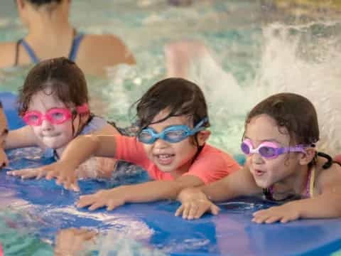 a group of children in a pool