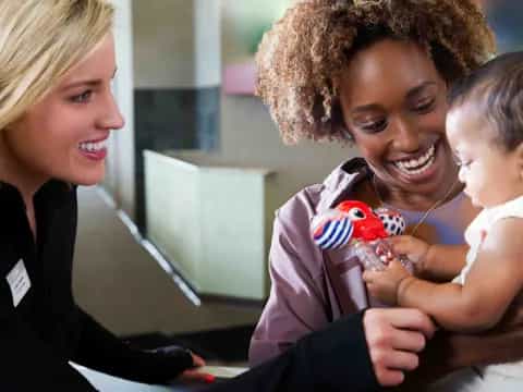 a woman holding a baby