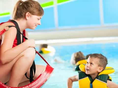 a person and a boy in a pool