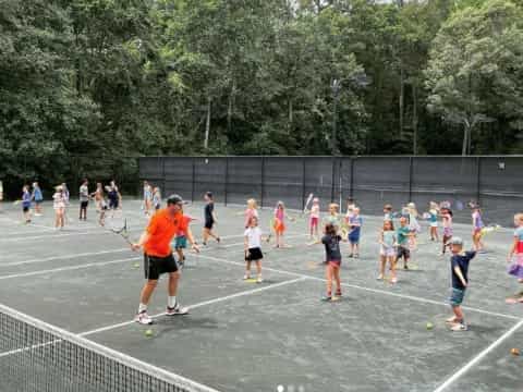 a group of people play tennis