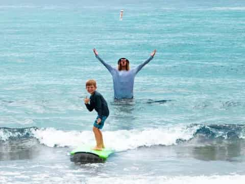 a man and a boy surfing