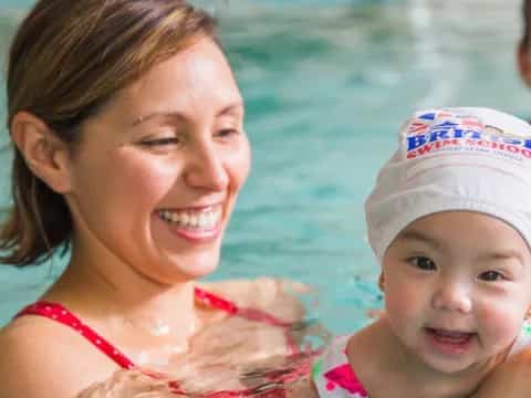 a person and a baby in a pool