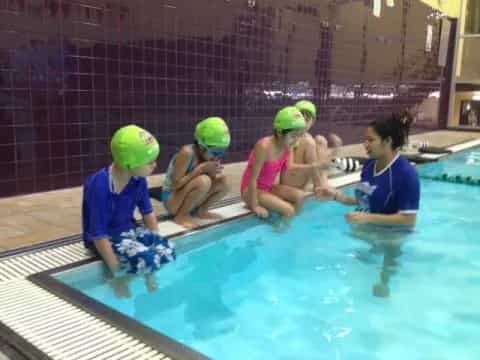 a group of kids in a pool