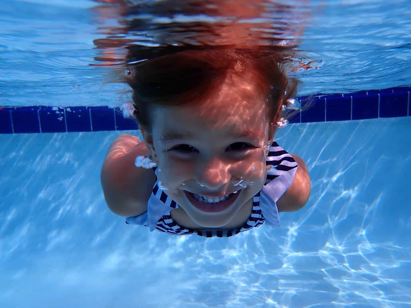 a boy swimming in a pool