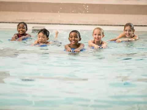 a group of children in a pool