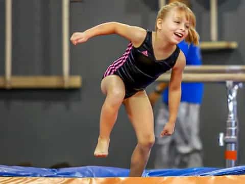 a girl jumping on a trampoline