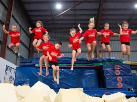 a group of children jumping on a trampoline
