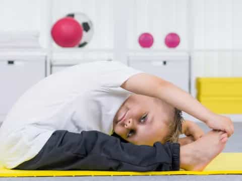 a child lying on a mat