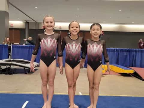 a group of women in swimsuits standing on a mat