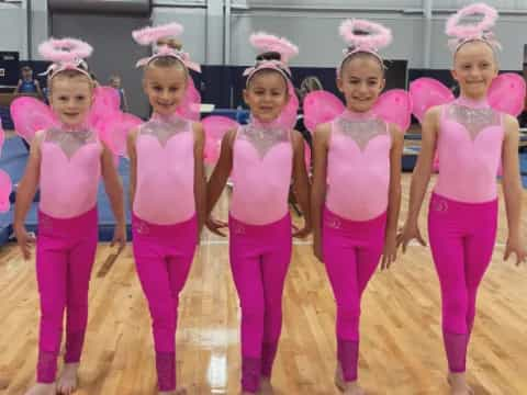 a group of girls in pink outfits