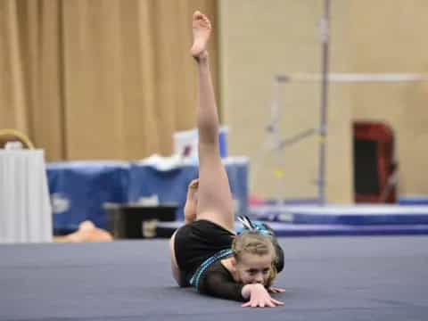 a person doing a handstand on a mat