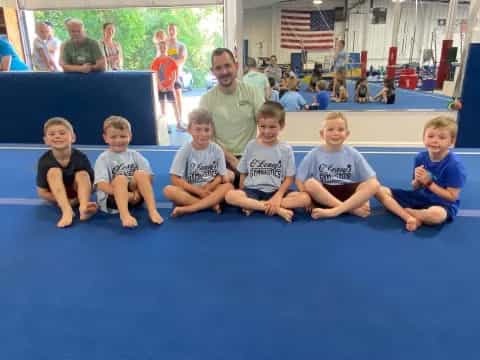 a group of kids sitting on a mat