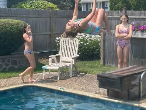 a person jumping into a pool