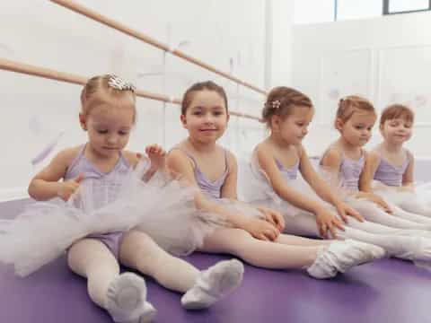 a group of girls in white dresses