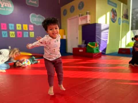 a young boy in a pink shirt