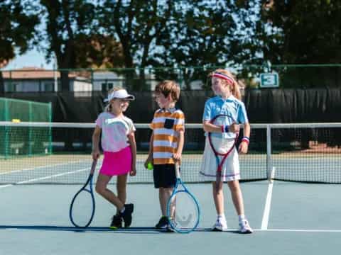 kids holding tennis rackets