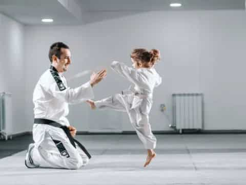 a man and a woman in karate uniforms