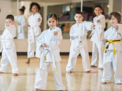 a group of children in karate uniforms