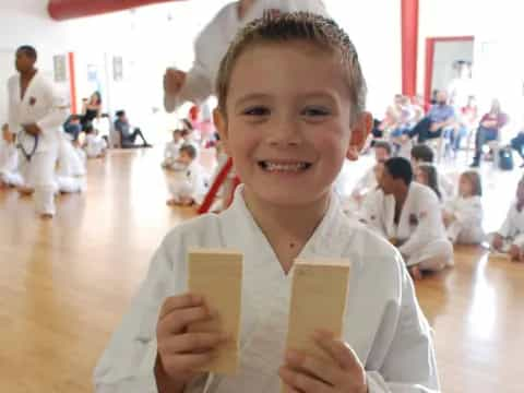 a young boy holding a paper money