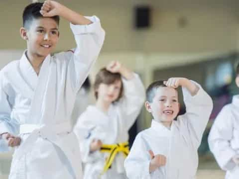 a group of children in karate uniforms