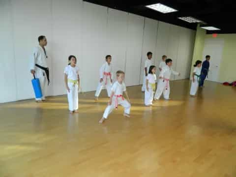 a group of people in karate uniforms