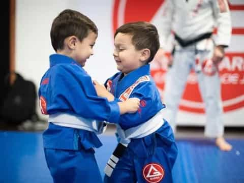 two boys in blue uniforms