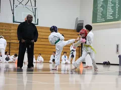 a group of kids in karate uniforms